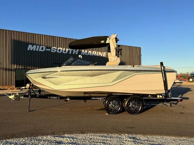 Slide: The Image of 2022 Nautique G23 boat on trailer at Mid-South Marine dealership. - 1