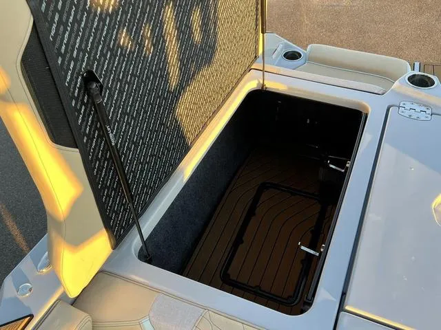 Slide: The Image of 2022 Nautique G23 boat storage compartment with open hatch. - 12