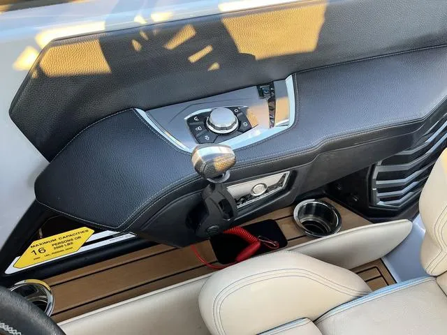 Slide: The Image of Interior dashboard of 2022 Nautique G23 boat with control panel and cup holders. - 14