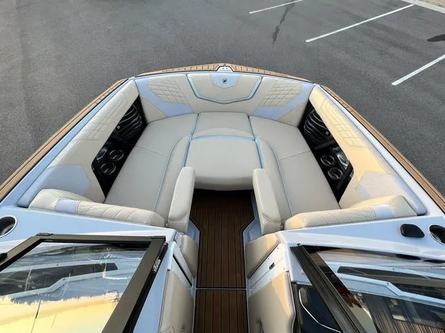 Slide: The Image of 2022 Nautique G23 boat interior with luxurious seating and modern design. - 21