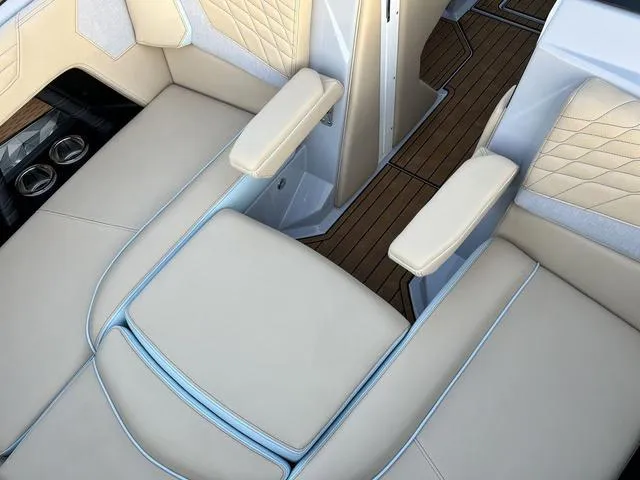 Slide: The Image of Luxurious interior of 2022 Nautique G23 boat with beige leather seating and wood flooring. - 22