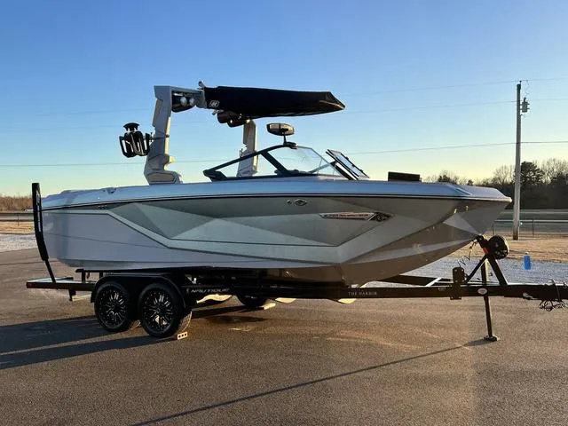Slide: The Image of 2022 Nautique G23 boat on trailer, sleek design, outdoor setting. - 4