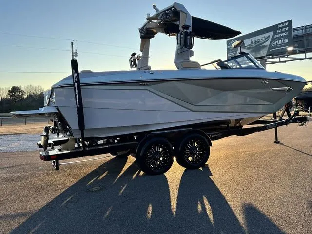 Slide: The Image of 2022 Nautique G23 boat on trailer, parked outdoors in sunlight. - 5