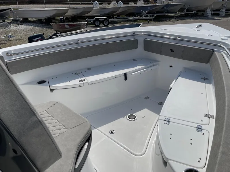 Slide: The Image of 2024 Sea Pro 242 Center Console boat interior with seating and storage compartments. - 7