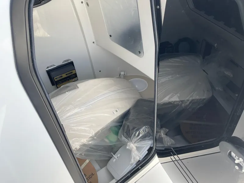 Slide: The Image of 2024 Sea Pro 242 Center Console boat interior with plastic-covered seating. - 8