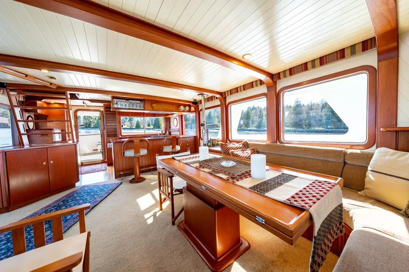 Slide: The Image of Luxurious interior of a 2002 North Sea Trawler with elegant wood finishes and large windows. - 10