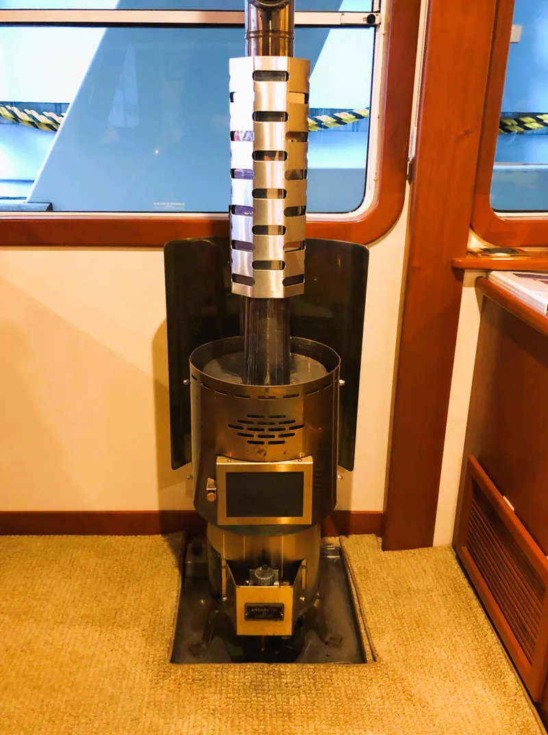 Slide: The Image of Interior of a 2002 North Sea Trawler featuring a modern stove heater. - 12