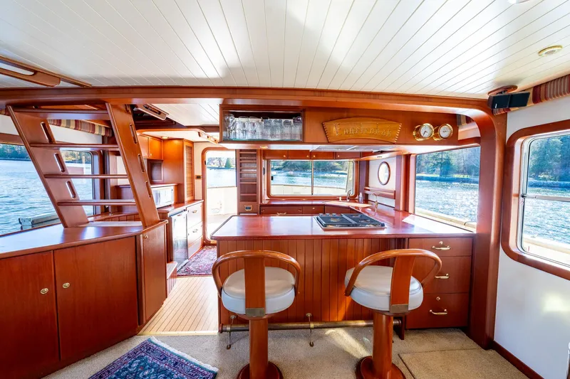 Slide: The Image of Luxurious 2002 North Sea Trawler interior with wooden finishes and scenic water views. - 13