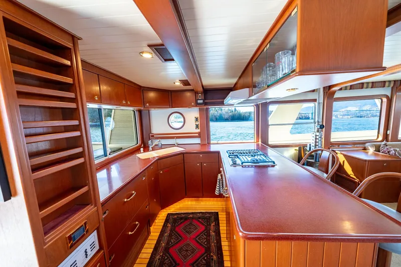 Slide: The Image of Luxurious North Sea Trawler 2002 interior with wooden cabinetry and scenic window views. - 15