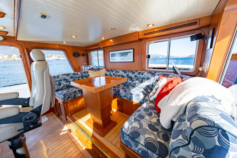 Slide: The Image of Luxurious North Sea Trawler interior with plush seating, wooden table, and scenic ocean views. - 25