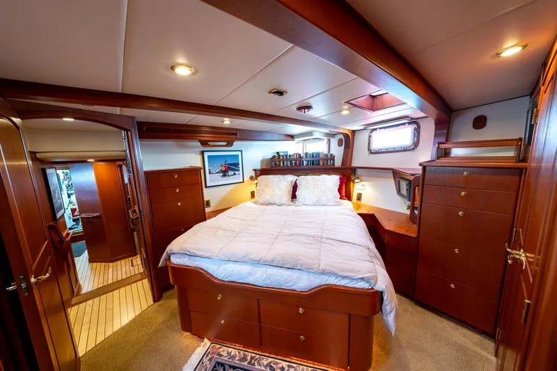 Slide: The Image of Luxurious cabin interior of a 2002 North Sea Trawler with wood furnishings and cozy bedding. - 28