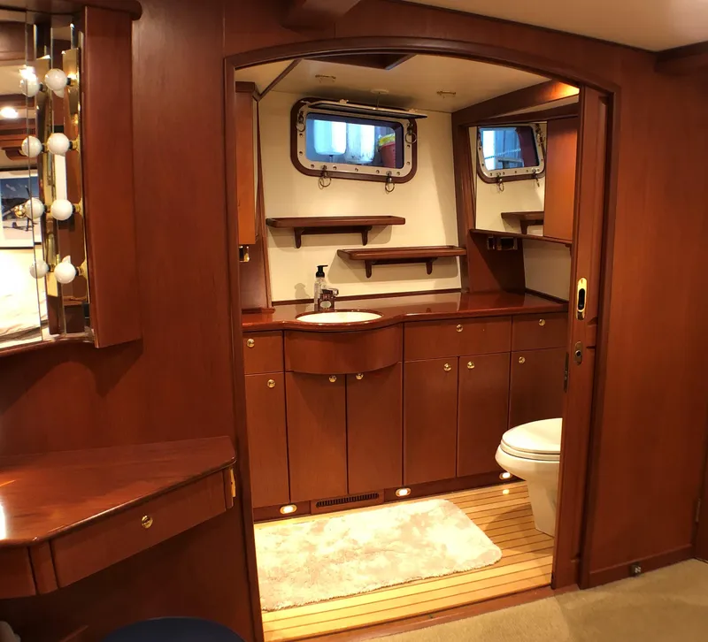 Slide: The Image of Luxurious wooden interior of a 2002 North Sea Trawler bathroom with vanity and porthole windows. - 32