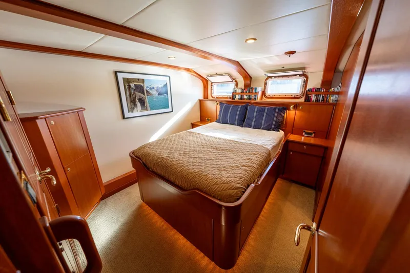 Slide: The Image of Luxurious cabin interior of a 2002 North Sea Trawler with cozy bed and wooden furnishings. - 36