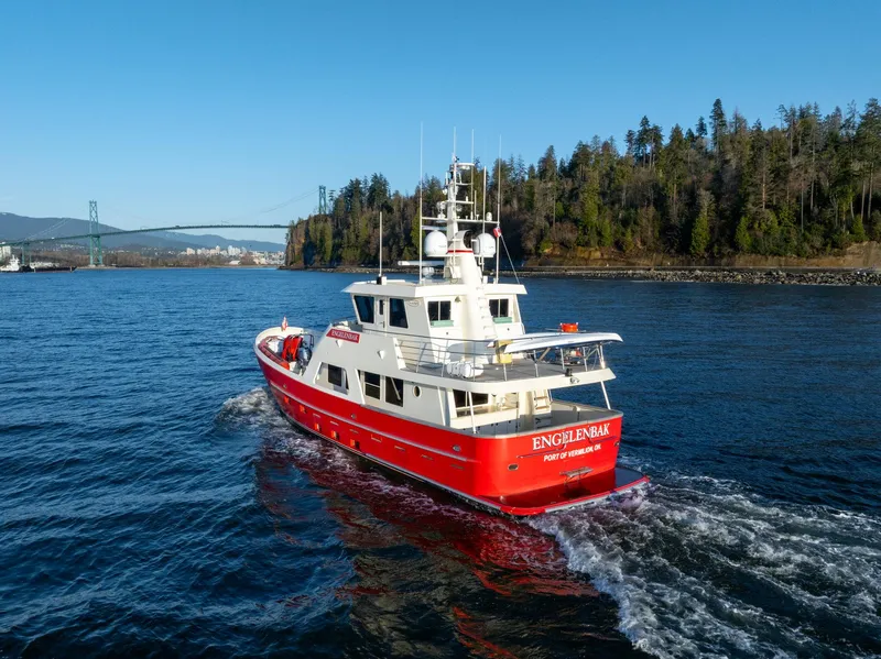 Slide: The Image of Red North Sea Trawler boat cruising near forested shoreline, 2002 model. - 4