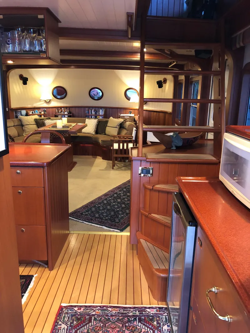 Slide: The Image of Interior of a 2002 North Sea Trawler, featuring cozy seating and wooden finishes. - 7