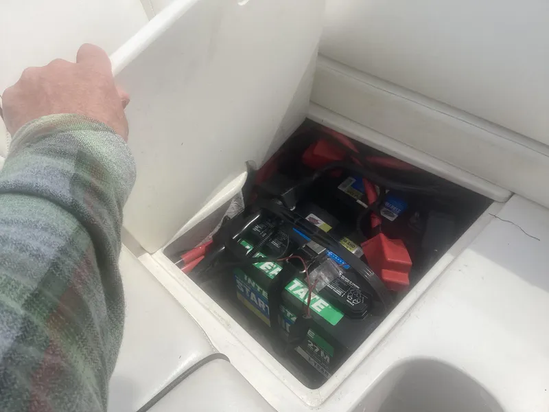 Slide: The Image of 2017 Sea Ray SDX 270 boat battery compartment with visible wiring and connections. - 18