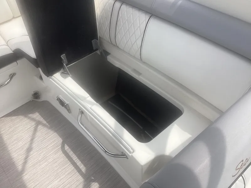 Slide: The Image of 2017 Sea Ray SDX 270 boat interior storage compartment with cushioned seating. - 20