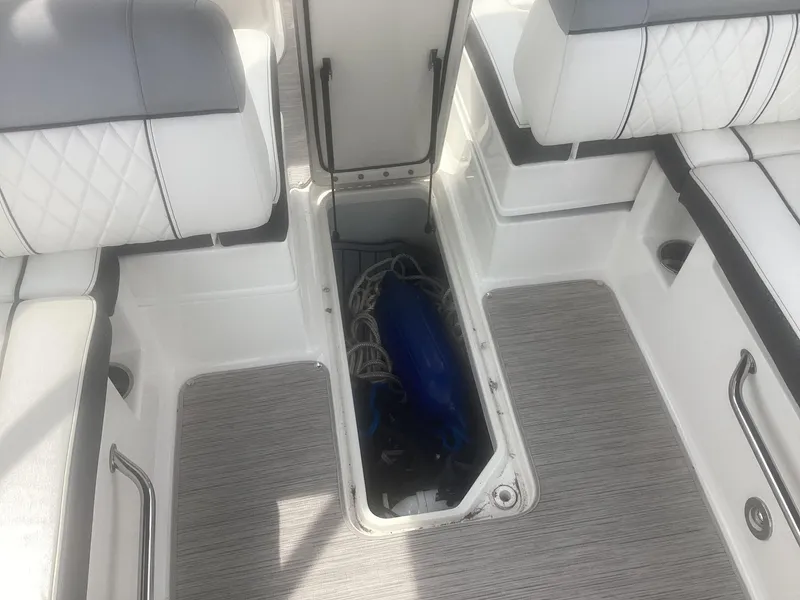Slide: The Image of 2017 Sea Ray SDX 270 boat interior with open storage compartment. - 22
