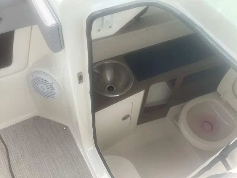 Slide: The Image of 2017 Sea Ray SDX 270 boat interior with sink and toilet. - 24