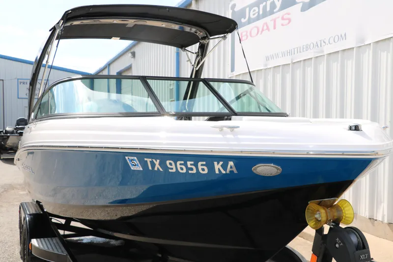 Slide: The Image of 2021 Regal 2000 ESX Bowrider boat on trailer, blue and white exterior. - 11