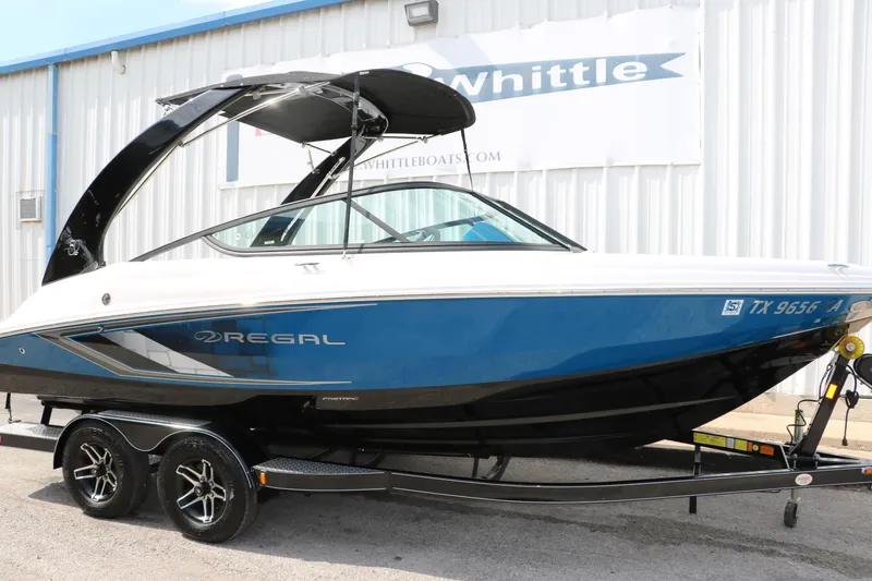 Slide: The Image of 2021 Regal 2000 ESX Bowrider boat on trailer outside dealership. - 14