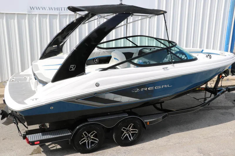 Slide: The Image of 2021 Regal 2000 ESX Bowrider boat on trailer, side view. - 16