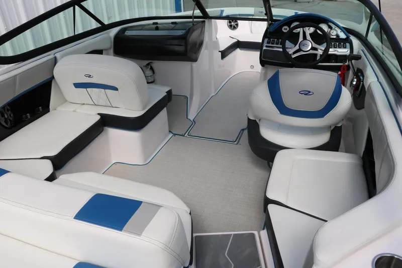 Slide: The Image of 2021 Regal 2000 ESX Bowrider interior with white and blue seating, modern dashboard. - 22