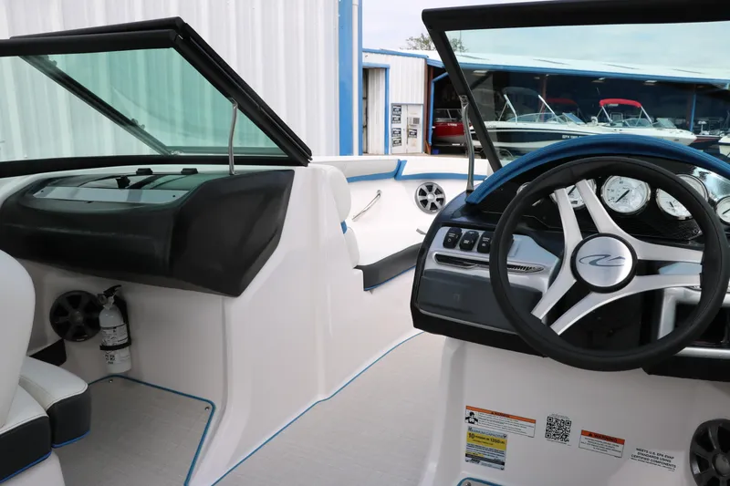 Slide: The Image of 2021 Regal 2000 ESX Bowrider interior, featuring steering wheel and dashboard controls. - 33
