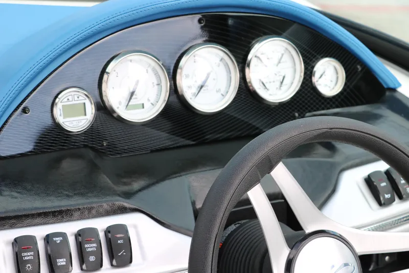 Slide: The Image of Dashboard of 2021 Regal 2000 ESX Bowrider boat with gauges and steering wheel. - 36