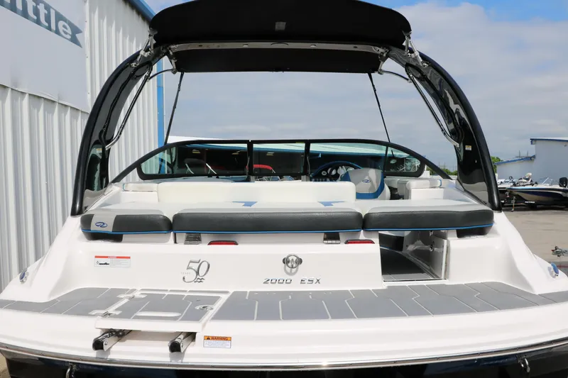 Slide: The Image of 2021 Regal 2000 ESX Bowrider boat with black canopy and white seating. - 5