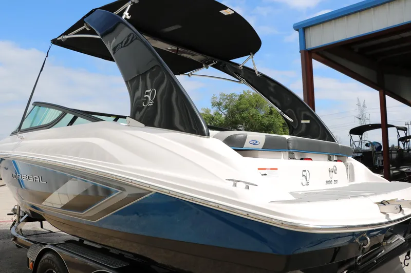 Slide: The Image of 2021 Regal 2000 ESX Bowrider boat with black canopy on trailer. - 6