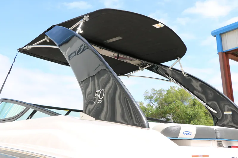 Slide: The Image of 2021 Regal 2000 ESX Bowrider with black bimini top and 50th anniversary logo. - 8