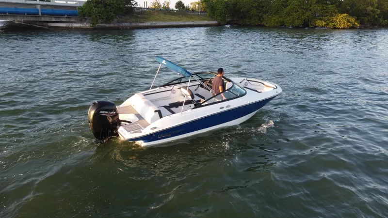 Slide: The Image of 2020 Monterey M205 boat cruising on a calm lake with a person onboard. - 10