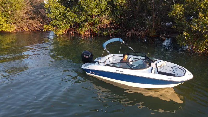 Slide: The Image of 2020 Monterey M205 boat cruising near lush green shoreline. - 12