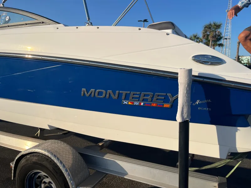 Slide: The Image of 2020 Monterey M205 boat on a trailer, blue and white exterior. - 14