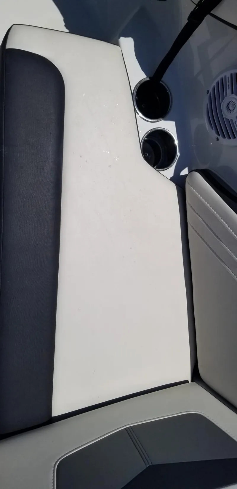 Slide: The Image of 2020 Monterey M205 boat interior with white and black seating, cup holders, and speaker. - 25