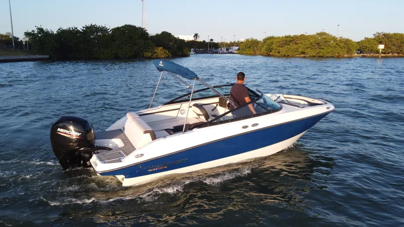 Slide: The Image of 2020 Monterey M205 boat cruising on a lake with a person at the helm. - 3