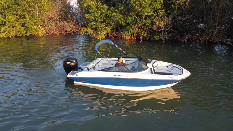Slide: The Image of 2020 Monterey M205 boat cruising on a calm river near lush greenery. - 6