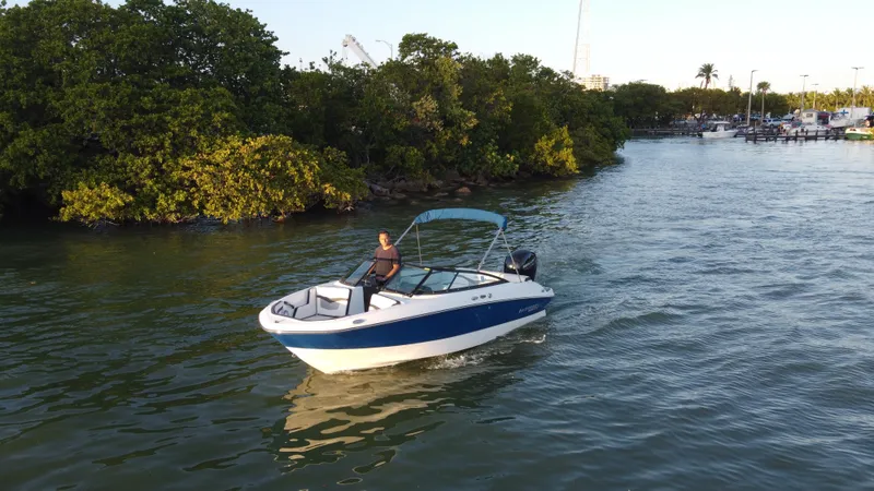 Slide: The Image of 2020 Monterey M205 boat cruising near lush green shoreline. - 7