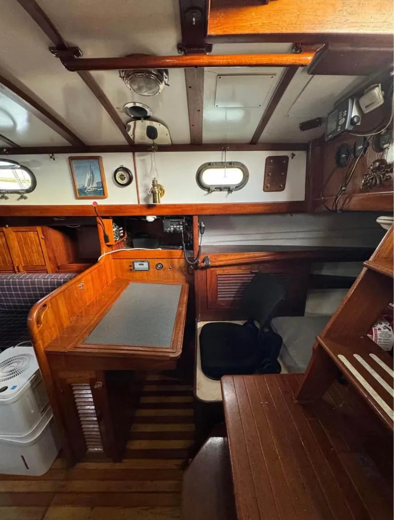 Slide: The Image of Interior of a 1977 Tayana 37 sailboat with wooden furnishings and nautical decor. - 5