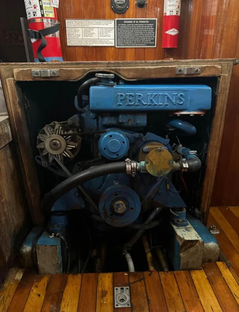Slide: The Image of Perkins engine in a 1977 Tayana 37 sailboat, with visible fire extinguishers. - 7