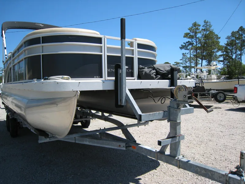 Slide: The Image of 2017 Bennington 22SLX pontoon boat on a trailer in a marina. - 6
