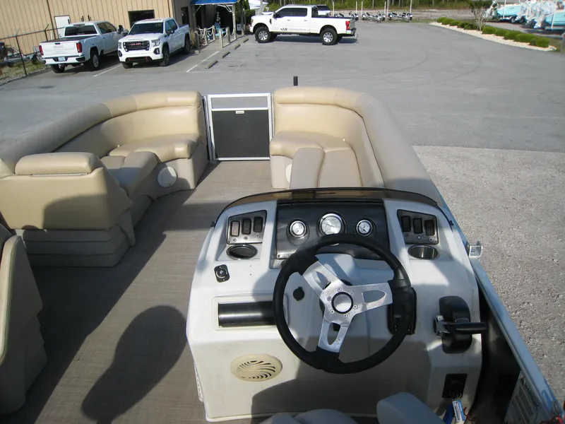 Slide: The Image of Interior view of 2017 Bennington 22SLX pontoon boat with beige seating and control panel. - 8