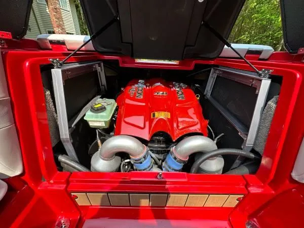 Slide: The Image of 2017 Malibu 24' WAKESETTER MXZ engine compartment with red engine cover. - 17
