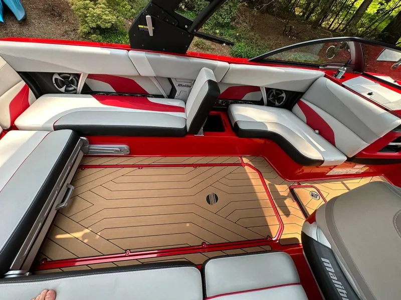Slide: The Image of 2017 Malibu 24' WAKESETTER MXZ interior with red and white seating and teak flooring. - 9