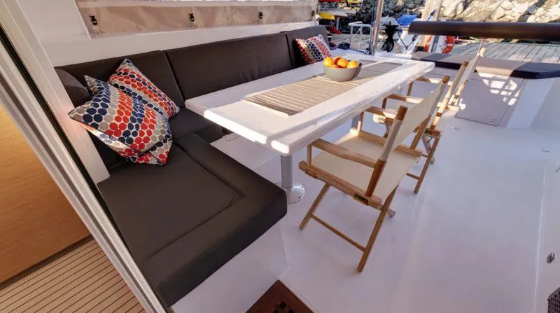 Slide: The Image of Nautitech 40 Open 2016 yacht interior with dining area, cushioned seating, and decorative pillows. - 12