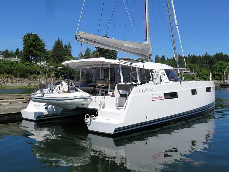 Slide: The Image of 2016 Nautitech 40 Open catamaran docked in a serene marina. - 17