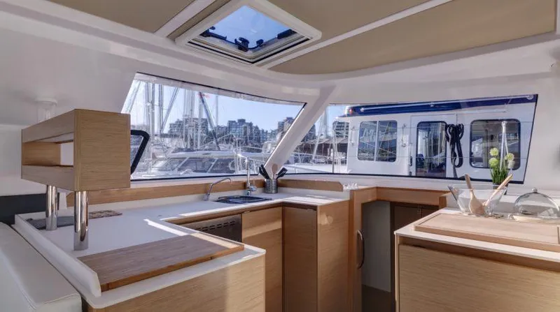Slide: The Image of Interior of 2016 Nautitech 40 Open catamaran with modern kitchen and marina view. - 2