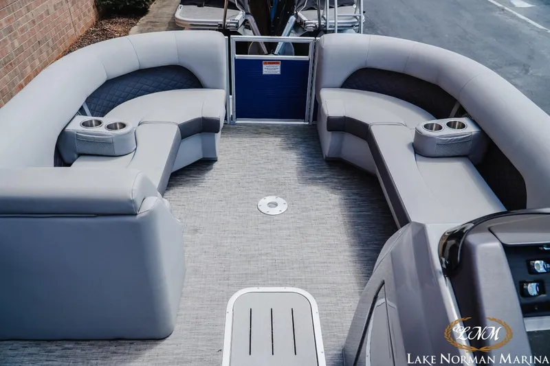Slide: The Image of 2023 Bennington 23LSR pontoon boat interior with plush seating and cup holders at Lake Norman Marina. - 10