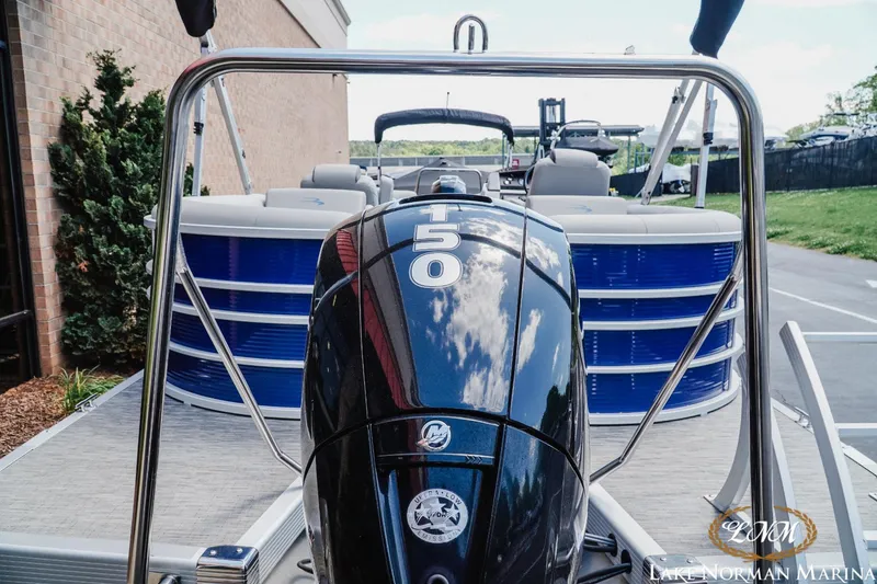 Slide: The Image of 2023 Bennington 23LSR pontoon boat with a 150 HP Mercury outboard motor. - 4